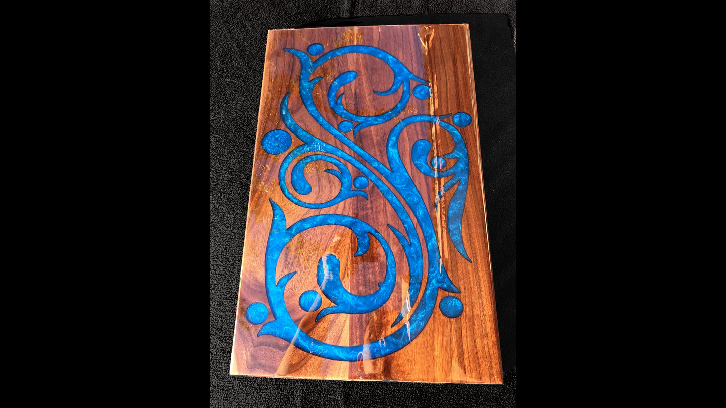 Top View of a blue epoxy script style inlaid into a 20X13X3/4" piece of walnut, and finished with a glasslike smooth epoxy finish.