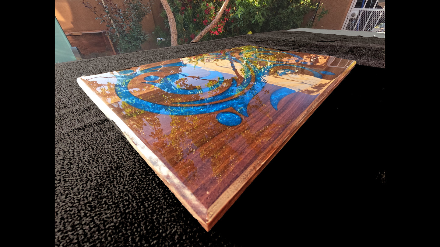 Low corner view of a blue epoxy script style inlaid into a 20X13X3/4" piece of walnut and finished with a glasslike smooth epoxy finish